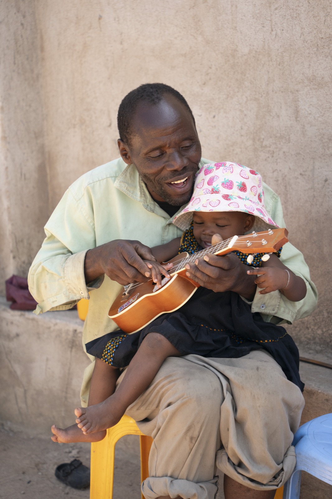 A man sitting with a young child