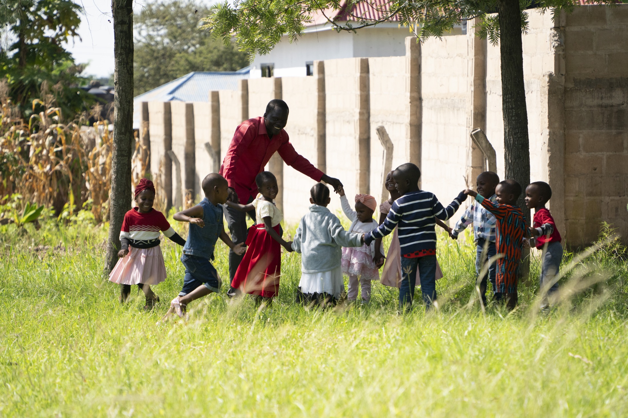 Children holding hands outdoors in Tanzania